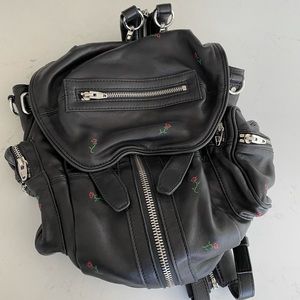 Twice used Alexander black with rose backpack.